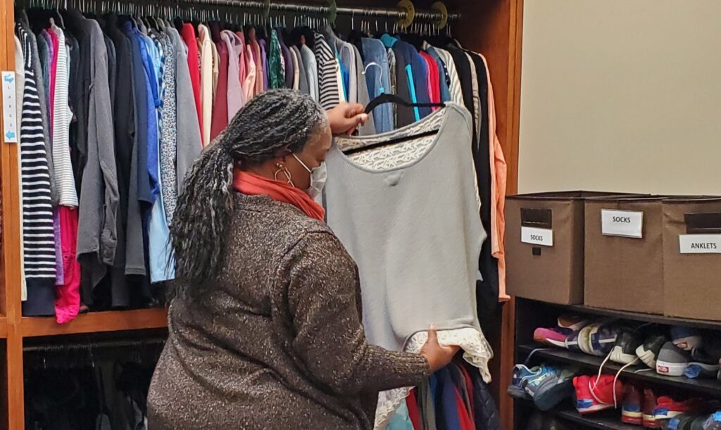 Anjie CC A volunteer chooses a shirt for a guest